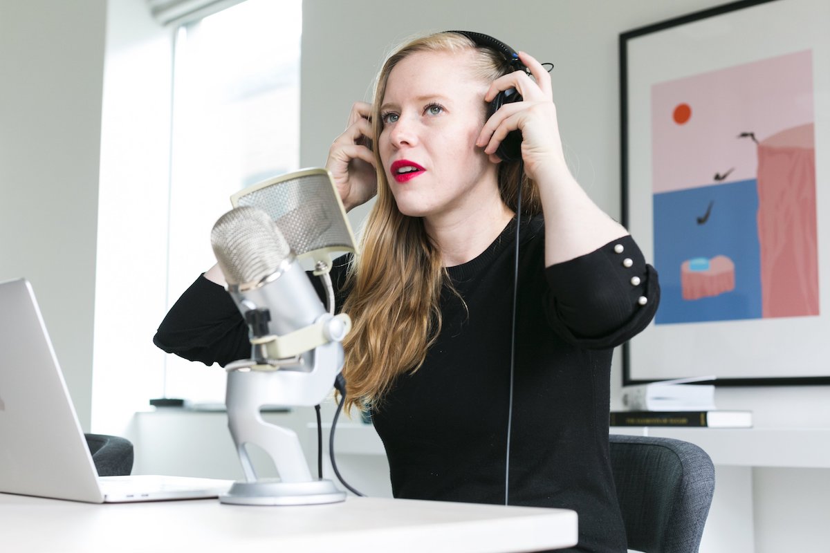 woman in headphones listening to dating podcasts
