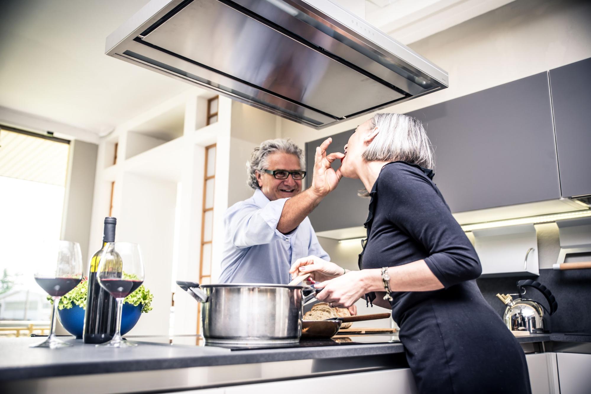 middle aged couple cooking